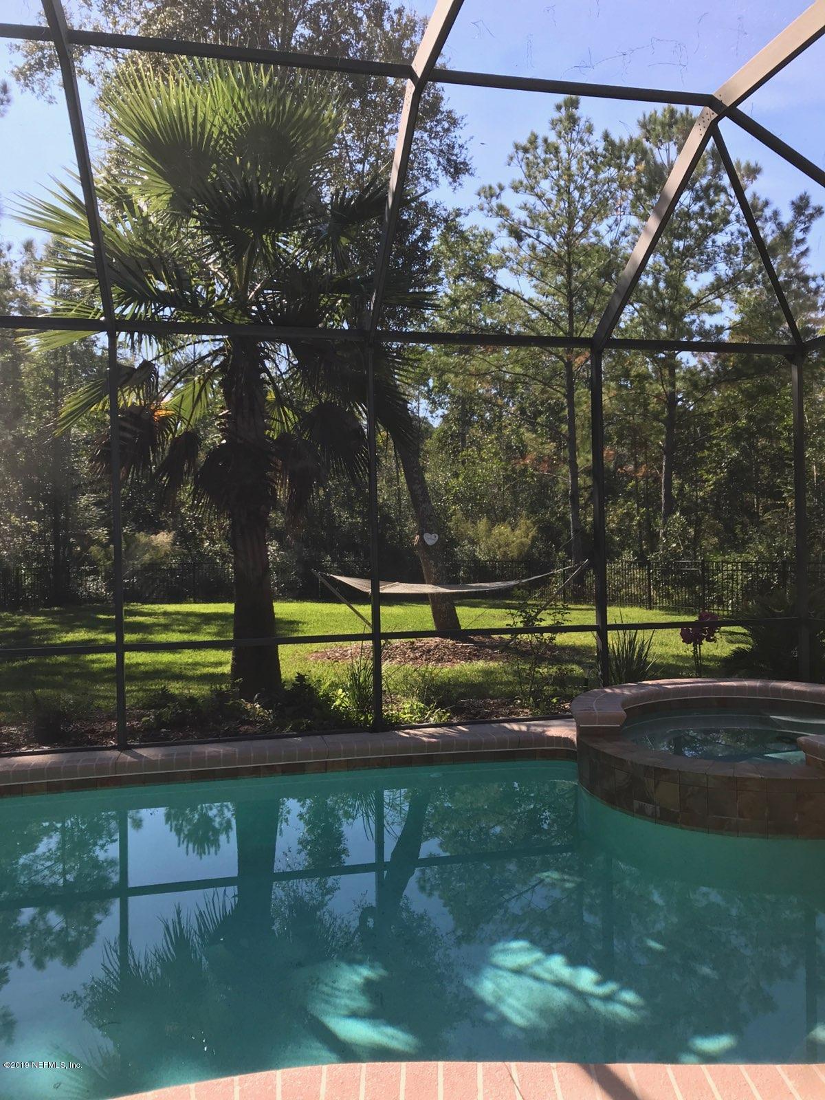 87465 Creekside Drive Yulee, FL 32097 - Photo 39 of 40 a view of a yard with a bench