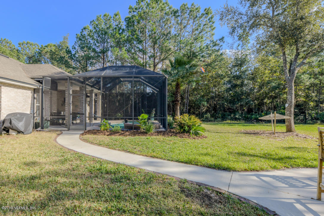87465 Creekside Drive Yulee, FL 32097 - Photo 6 of 40 a view of a swimming pool with a patio