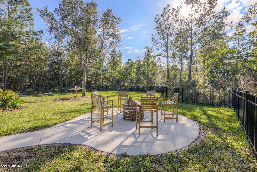 87465 Creekside Drive Yulee, FL 32097 - Photo 7 of 40 a view of a swimming pool with a patio