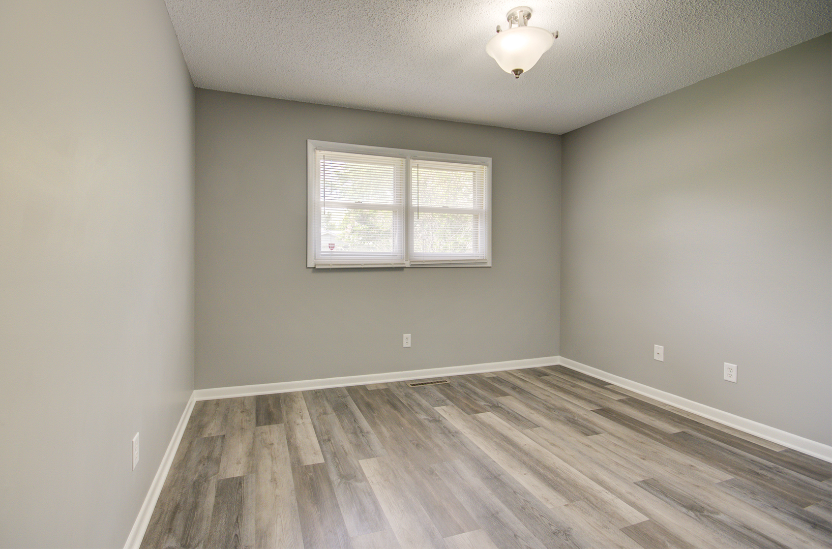 1354 Georgetown Drive Bourbonnais, IL 60914 - Photo 11 of 18 wooden floor in an empty room with a window