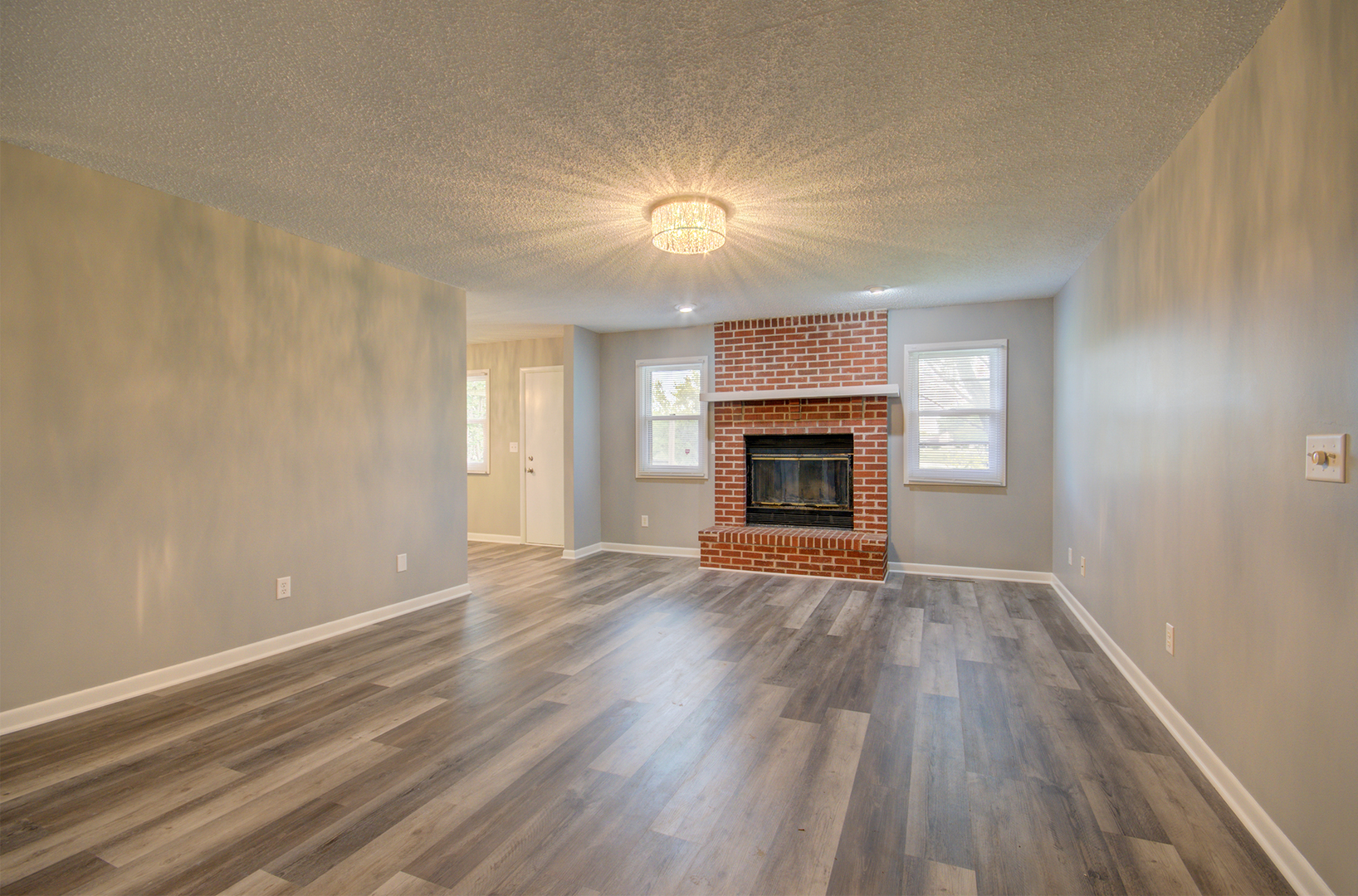 1354 Georgetown Drive Bourbonnais, IL 60914 - Photo 2 of 18 a view of empty room with wooden floor and fireplace