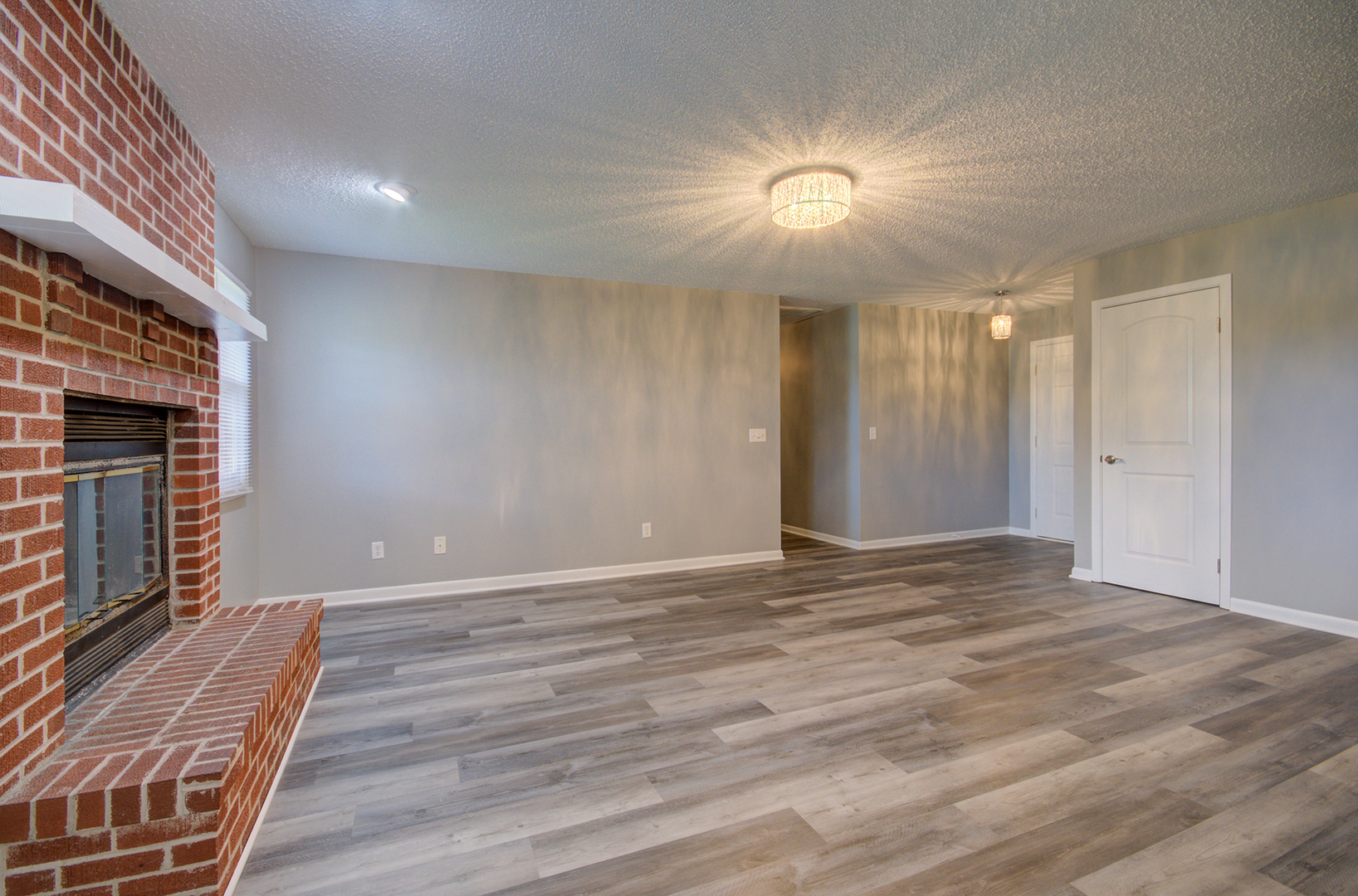 1354 Georgetown Drive Bourbonnais, IL 60914 - Photo 3 of 18 a view of an empty room with wooden floor and a fireplace