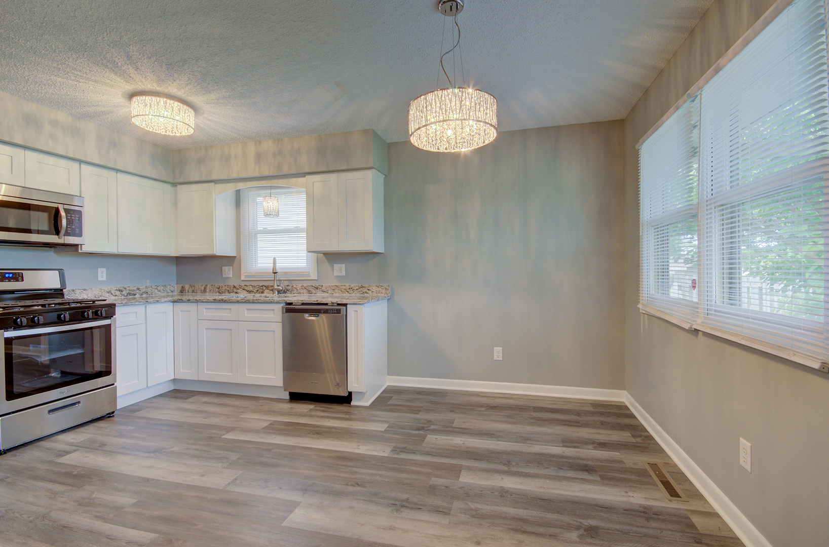 1354 Georgetown Drive Bourbonnais, IL 60914 - Photo 6 of 18 a kitchen with stainless steel appliances granite countertop a stove a sink and a microwave