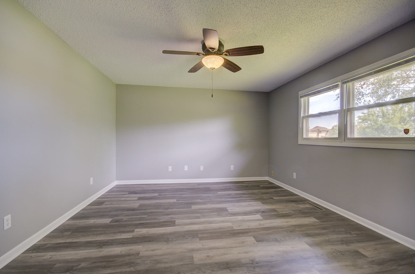 1354 Georgetown Drive Bourbonnais, IL 60914 - Photo 7 of 18 an empty room with wooden floor and windows