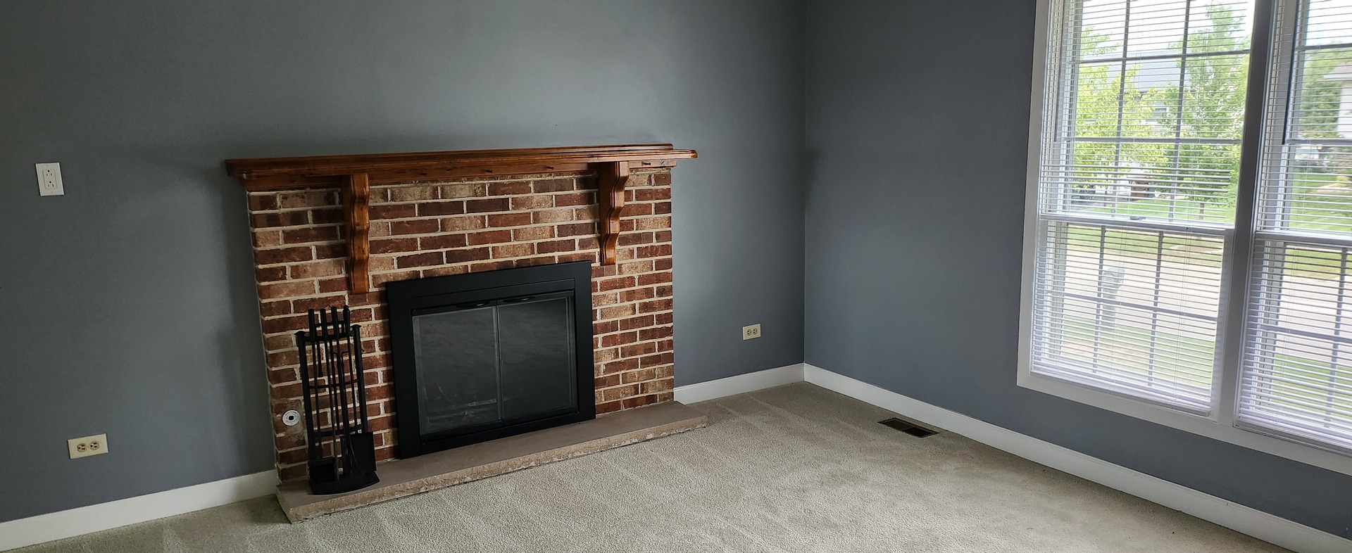 7306 West Mathews Drive Frankfort, IL 60423 - Photo 2 of 26 a view of an empty room with a fireplace and windows