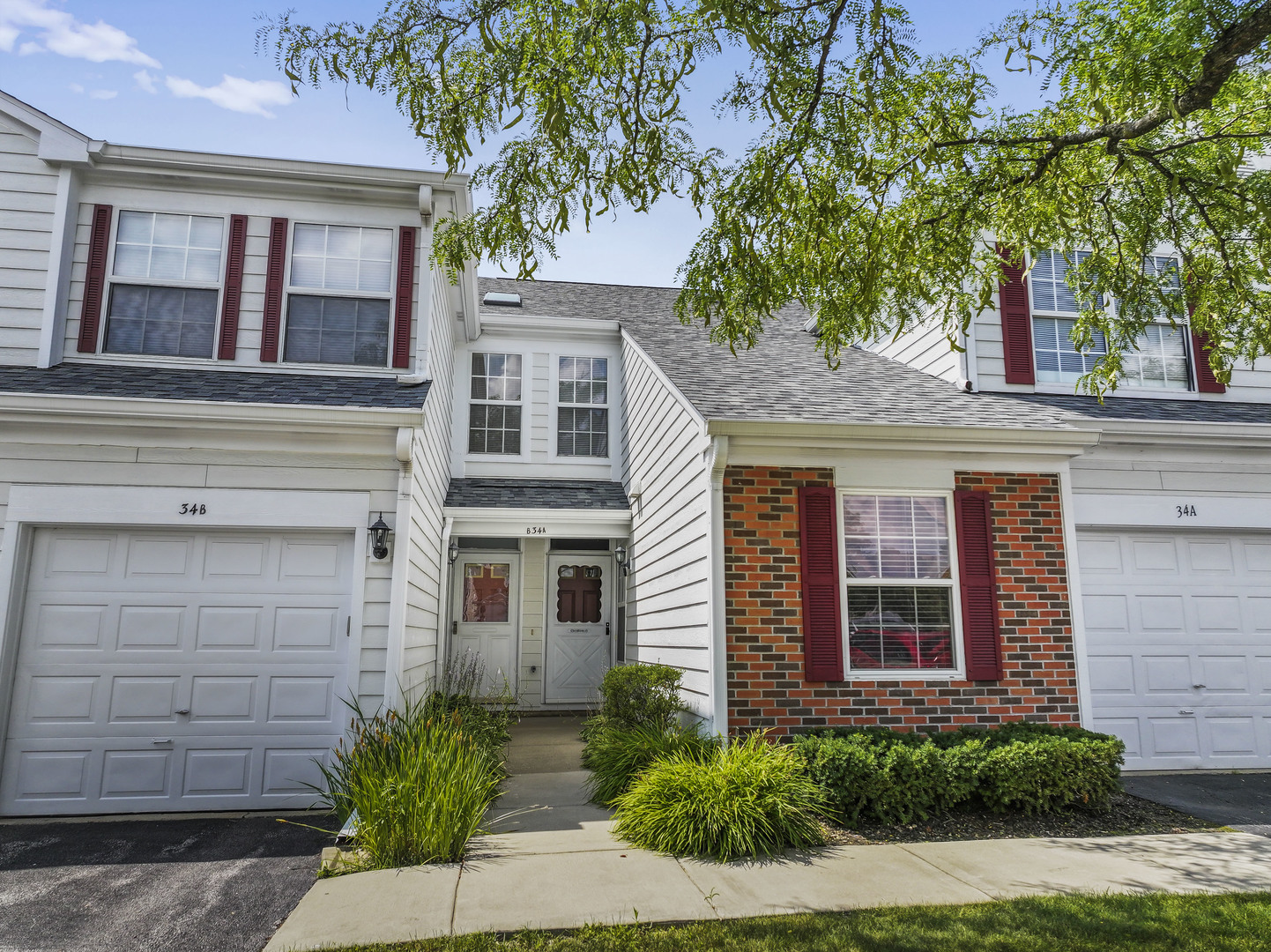 34 Coolidge Court, Unit A Streamwood, IL 60107 - Photo 1 of 1 a front view of a house with a yard and garage
