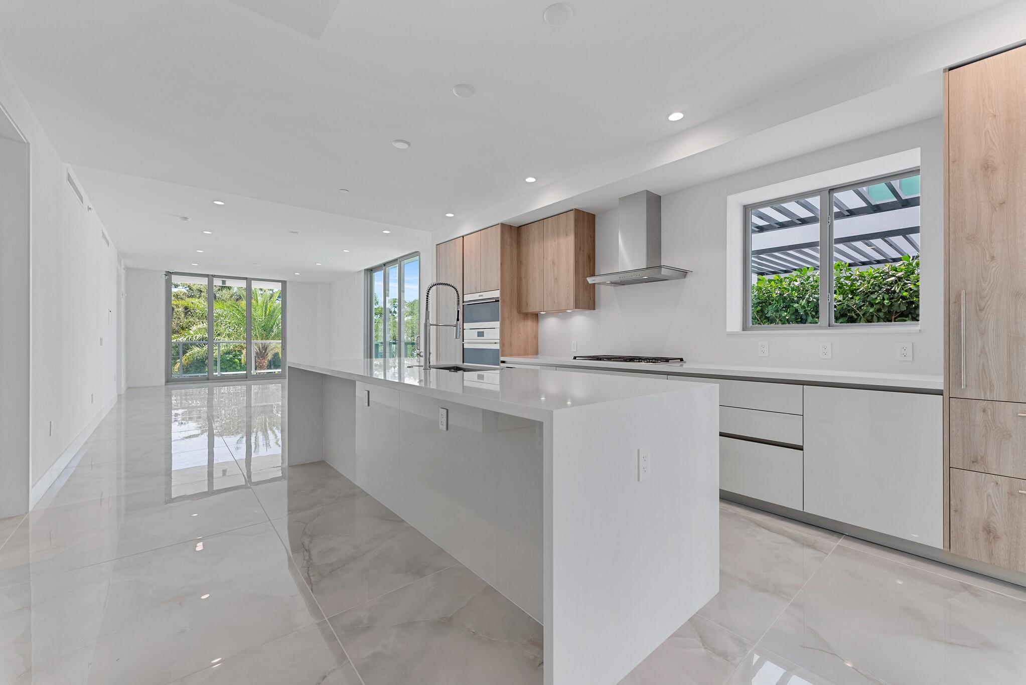 485 East Royal Palm Road, Unit 204 Boca Raton, FL 33432 - Photo 14 of 70 a kitchen with white cabinets and window