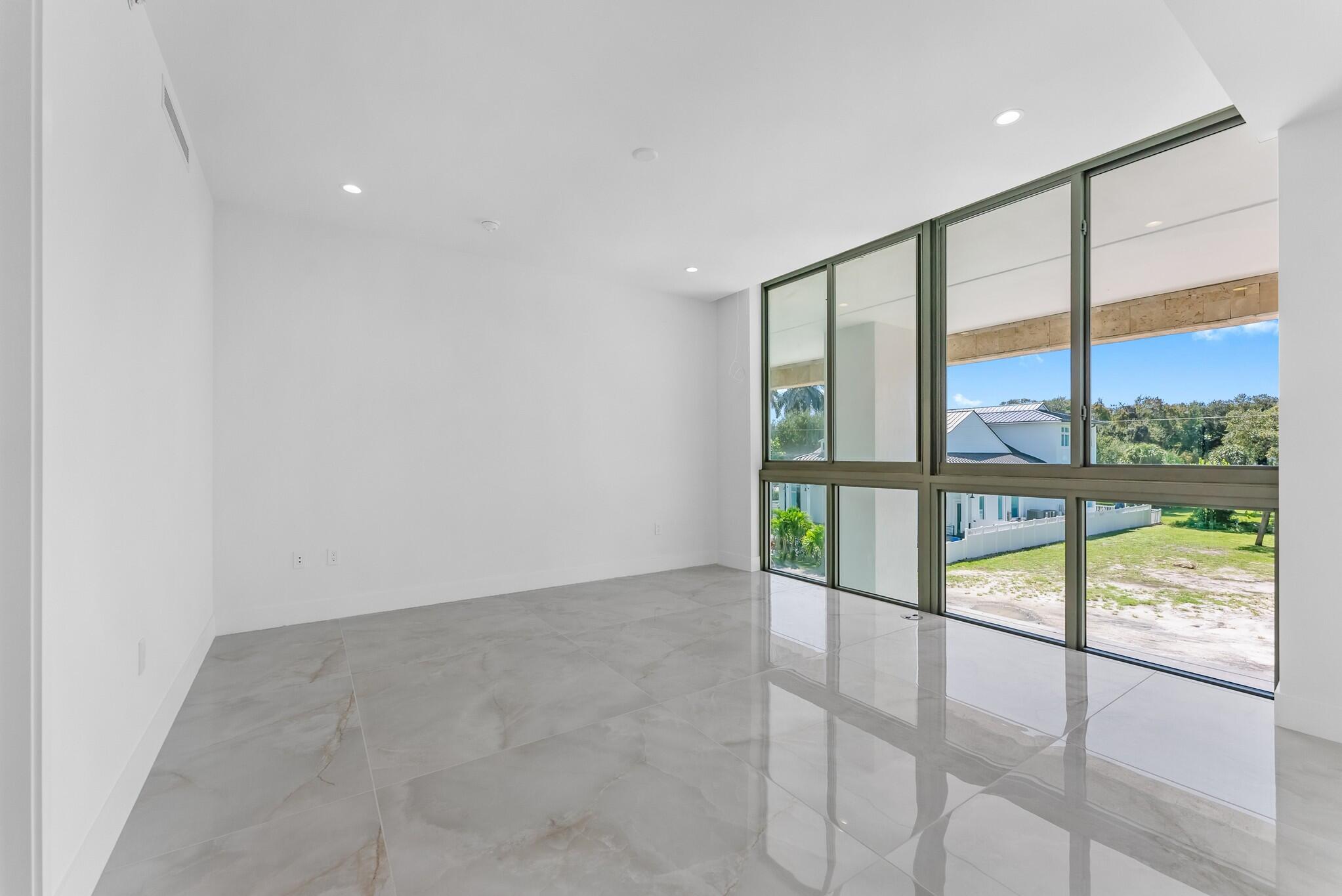 485 East Royal Palm Road, Unit 204 Boca Raton, FL 33432 - Photo 28 of 70 an empty room with wooden floor and glass door