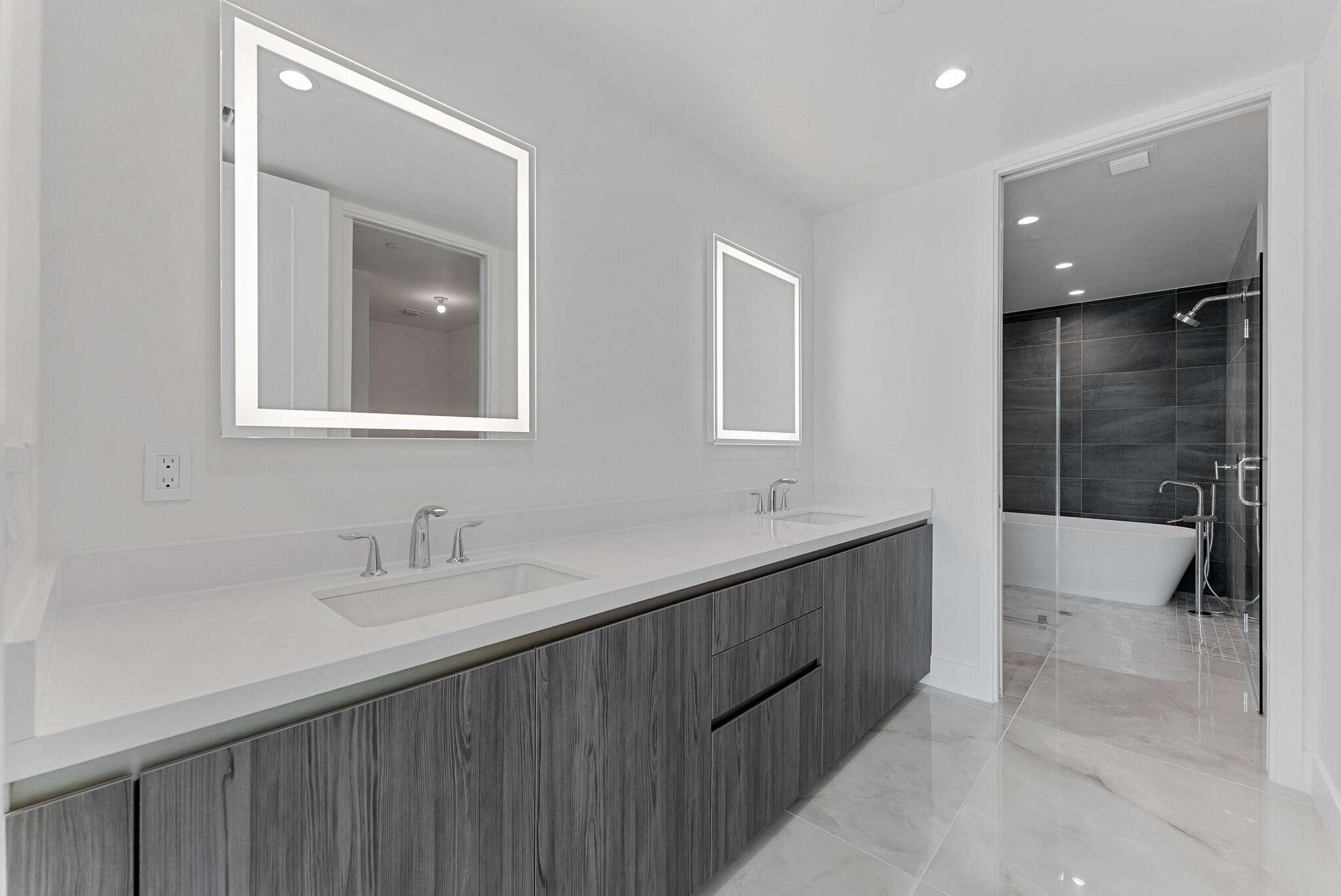 485 East Royal Palm Road, Unit 204 Boca Raton, FL 33432 - Photo 30 of 70 a bathroom with a double vanity sink and mirror with bathtub