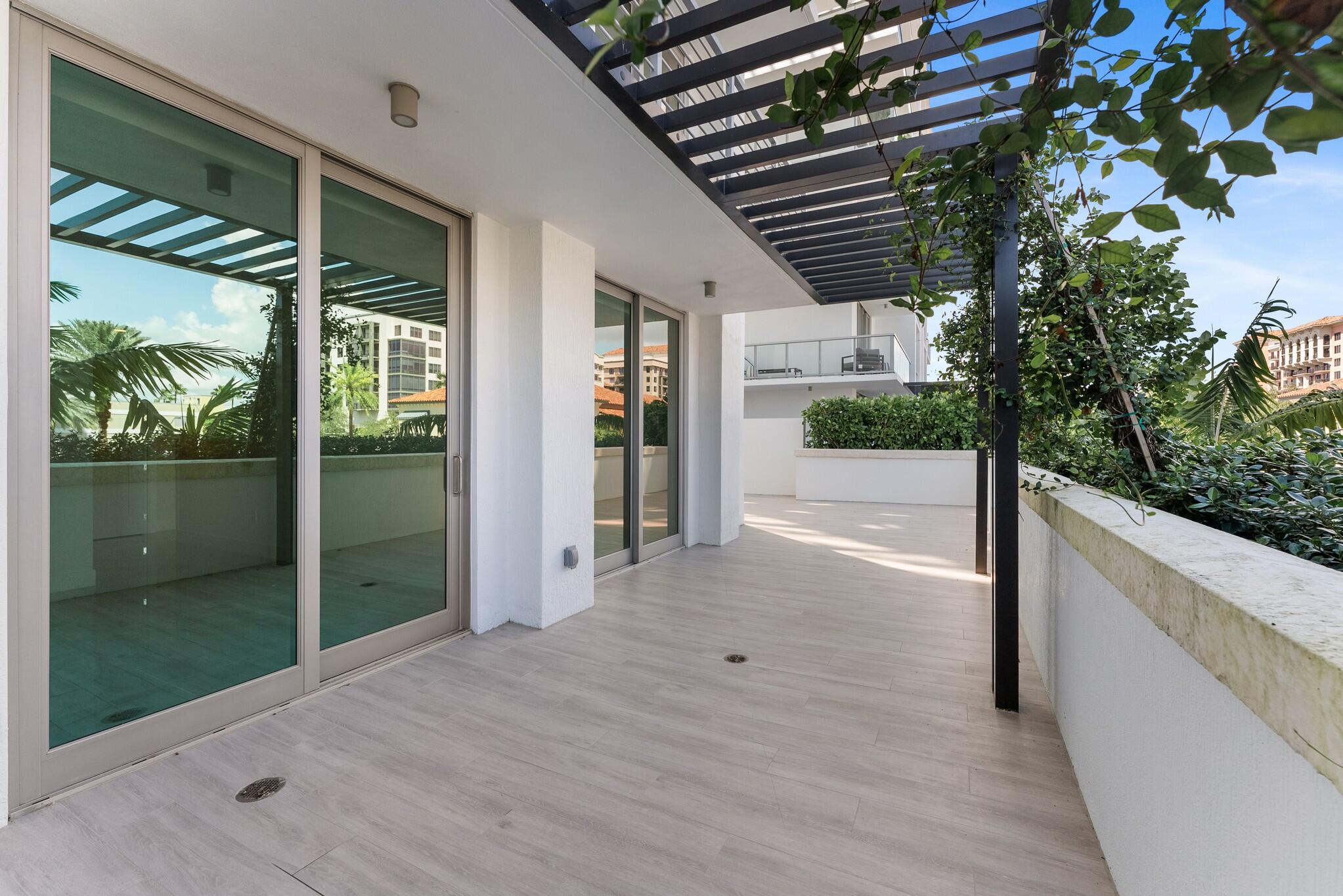 485 East Royal Palm Road, Unit 204 Boca Raton, FL 33432 - Photo 45 of 70 a view of a house with porch and wooden floor