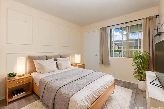 a bedroom with a bed and a potted plant