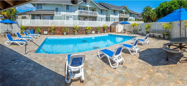 a view of a swimming pool with chairs