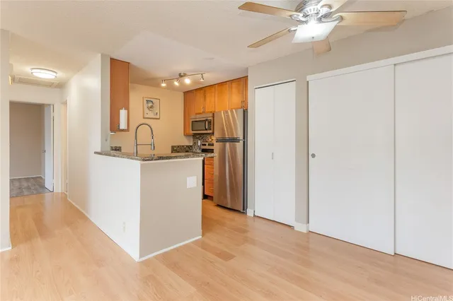 a kitchen with a refrigerator a sink and cabinets
