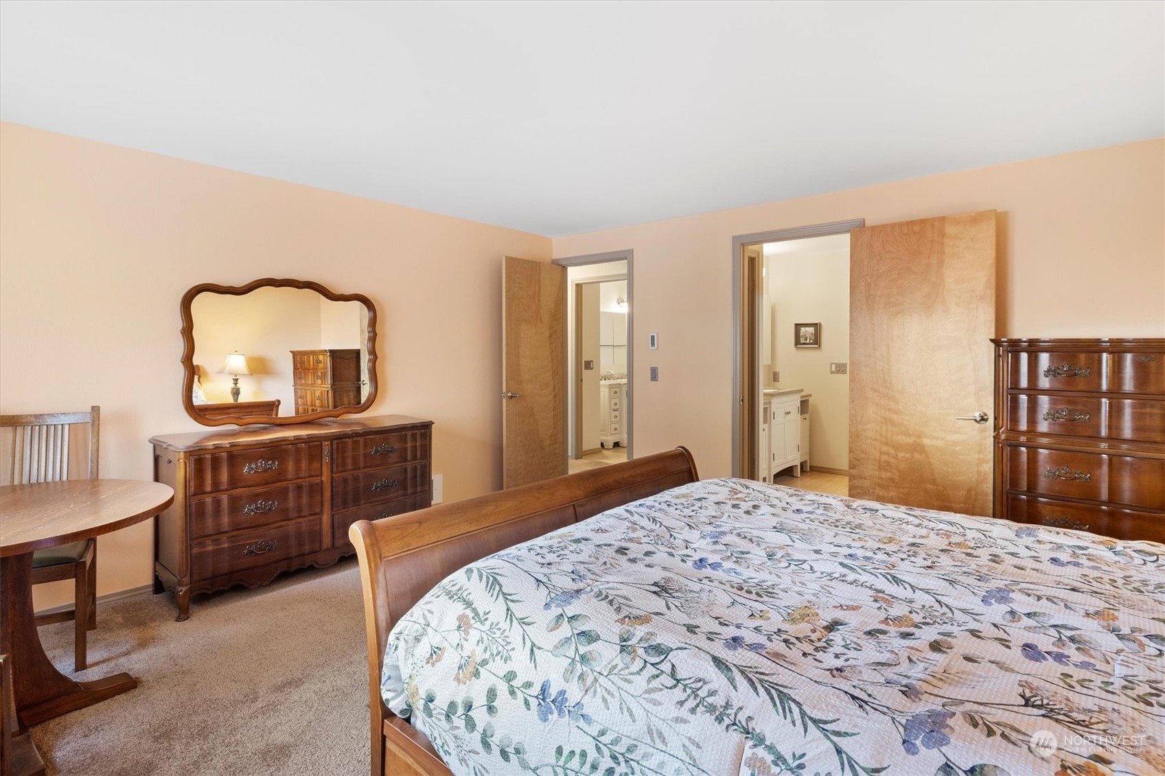201 3rd Avenue North, Unit 102 Edmonds, WA 98020 - Photo 18 of 39 a bedroom with a bed a dresser and mirror