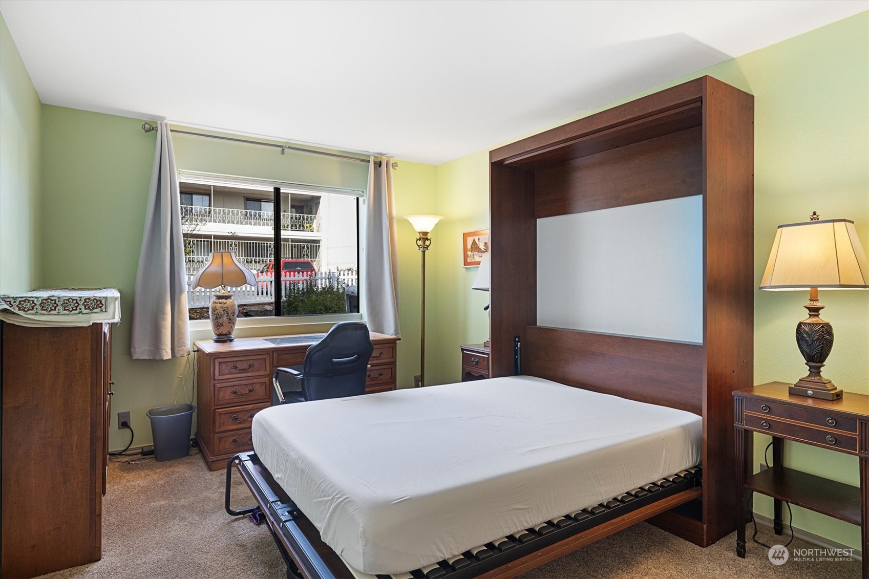 201 3rd Avenue North, Unit 102 Edmonds, WA 98020 - Photo 22 of 39 a large bed sitting in a bedroom next to a window