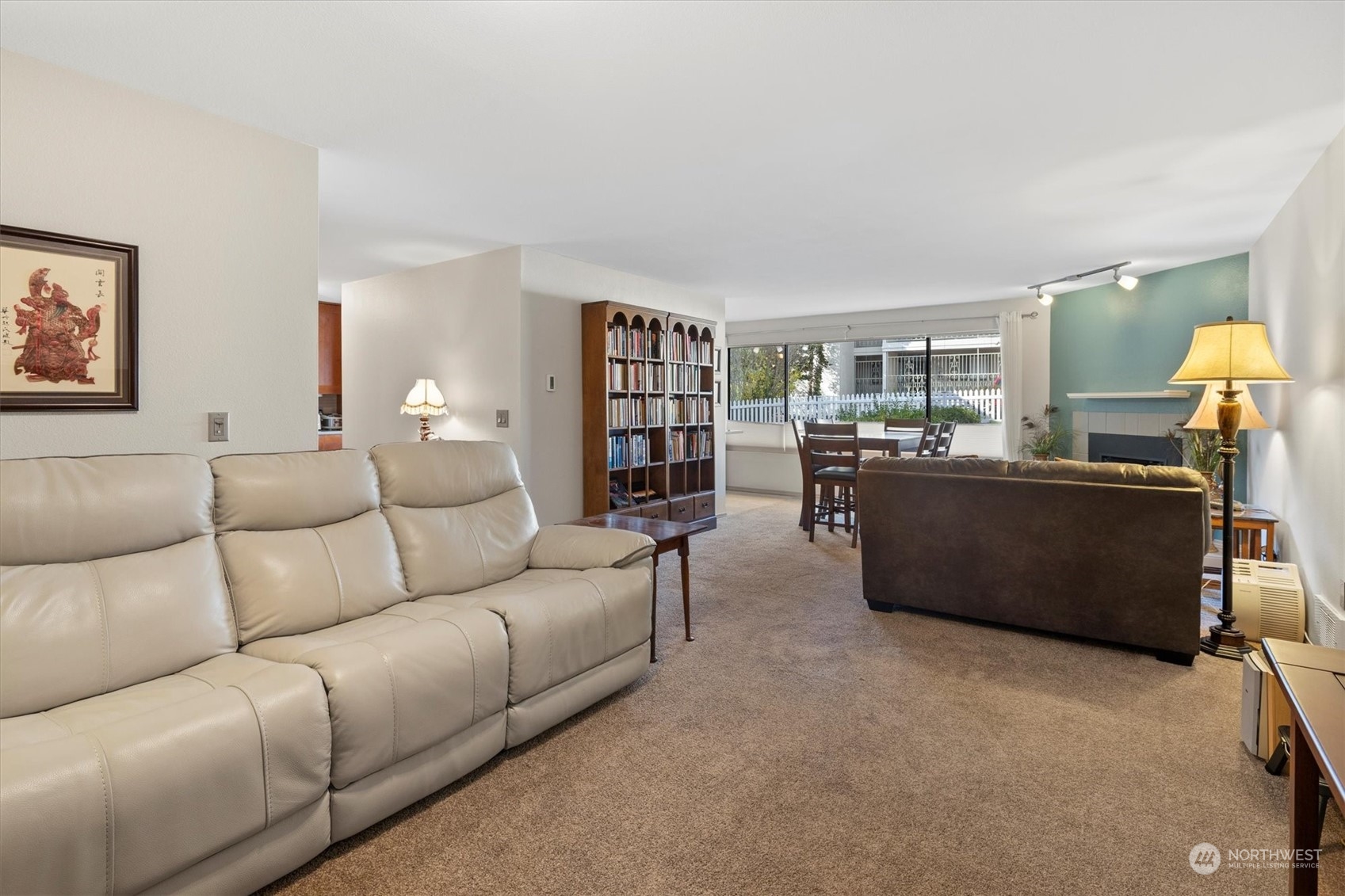 201 3rd Avenue North, Unit 102 Edmonds, WA 98020 - Photo 7 of 39 a living room with a couch and a bookshelf