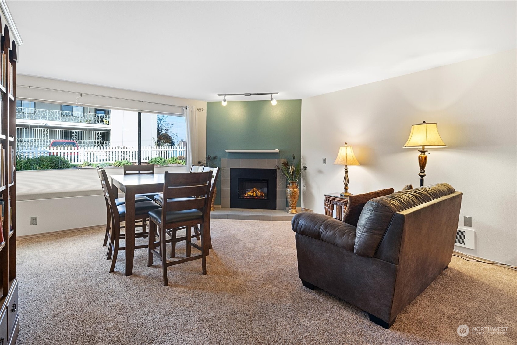 201 3rd Avenue North, Unit 102 Edmonds, WA 98020 - Photo 8 of 39 a living room with furniture a fireplace and a flat screen tv