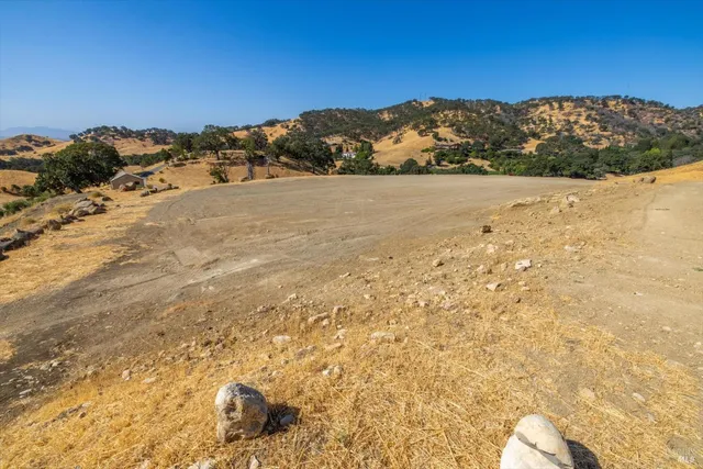 a view of mountain with sunset in background