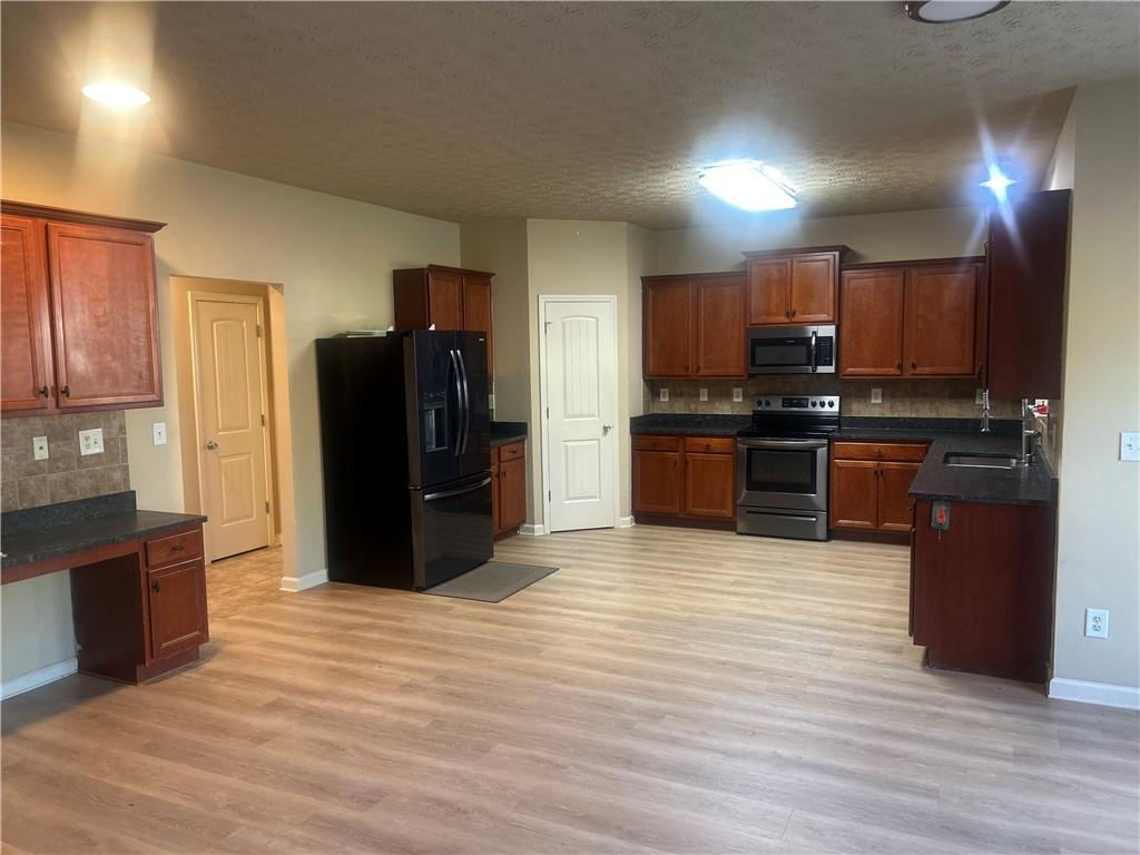 22 Pawnee Trail Fort Mitchell, AL 36856 - Photo 14 of 40 Wood-finish flooring throughout, complemented by dark wood cabinetry and dark stone-look countertops