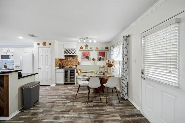 a dining room with furniture and kitchen view