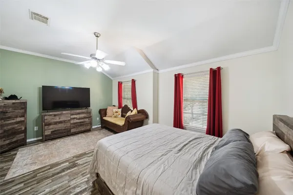 a bedroom with a bed and a flat screen tv