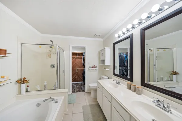 a bathroom with a double vanity sink mirror and shower