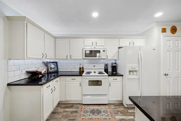 a kitchen with a sink a stove and refrigerator