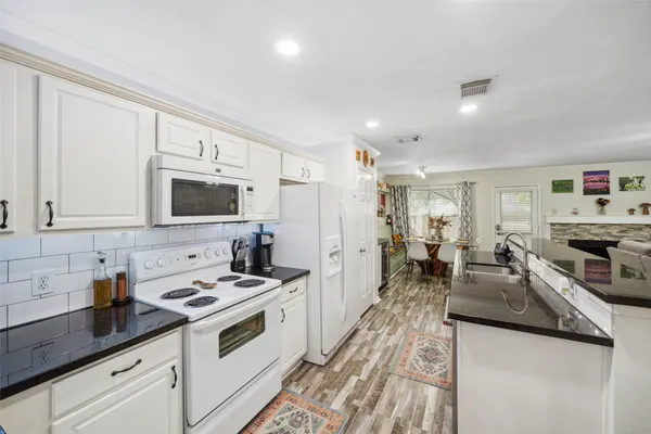 a kitchen with a sink stove and cabinets