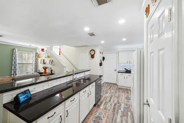 a kitchen with stainless steel appliances a sink and a refrigerator