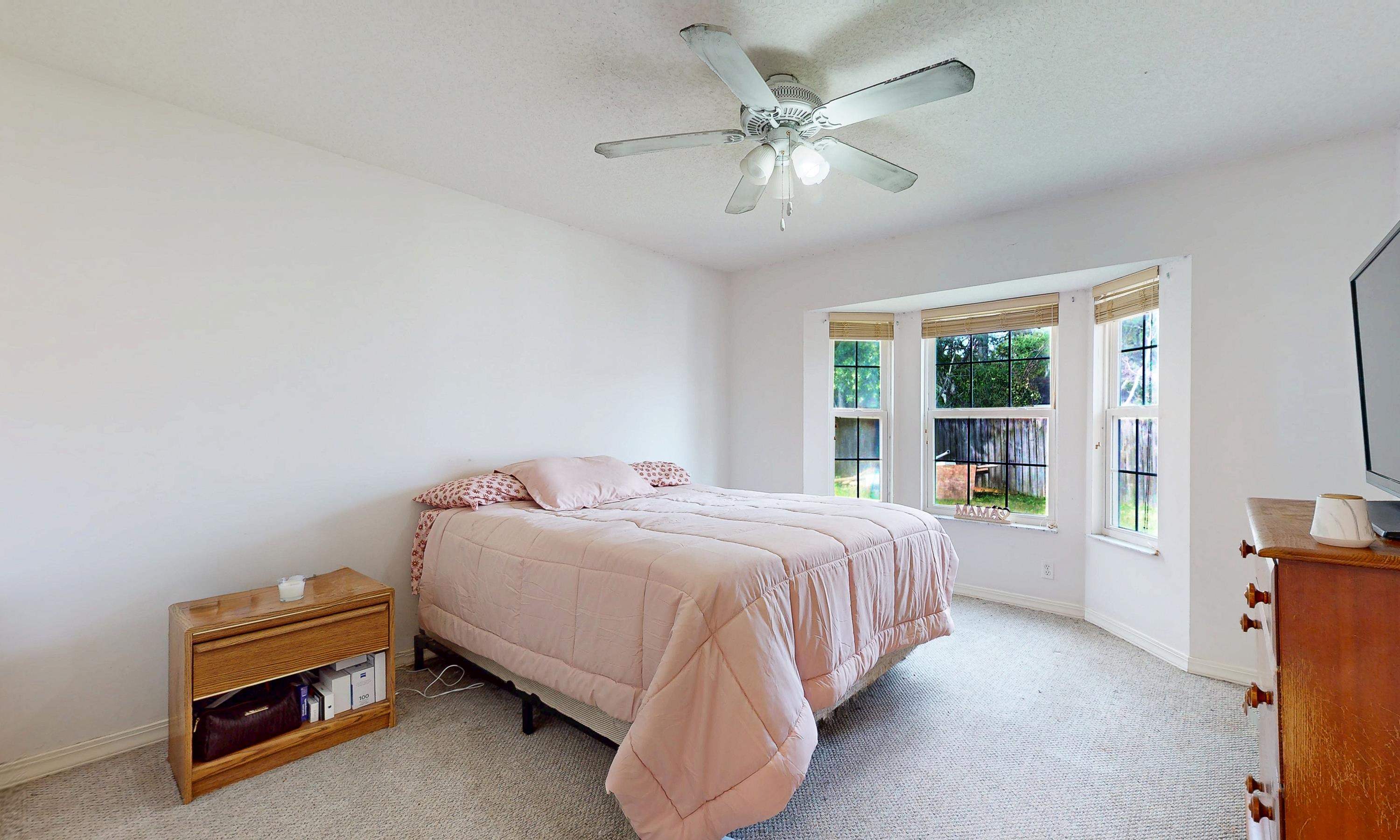 330 Segovia Road St. Augustine, FL 32086 - Photo 20 of 52 a bedroom with a bed and a chandelier