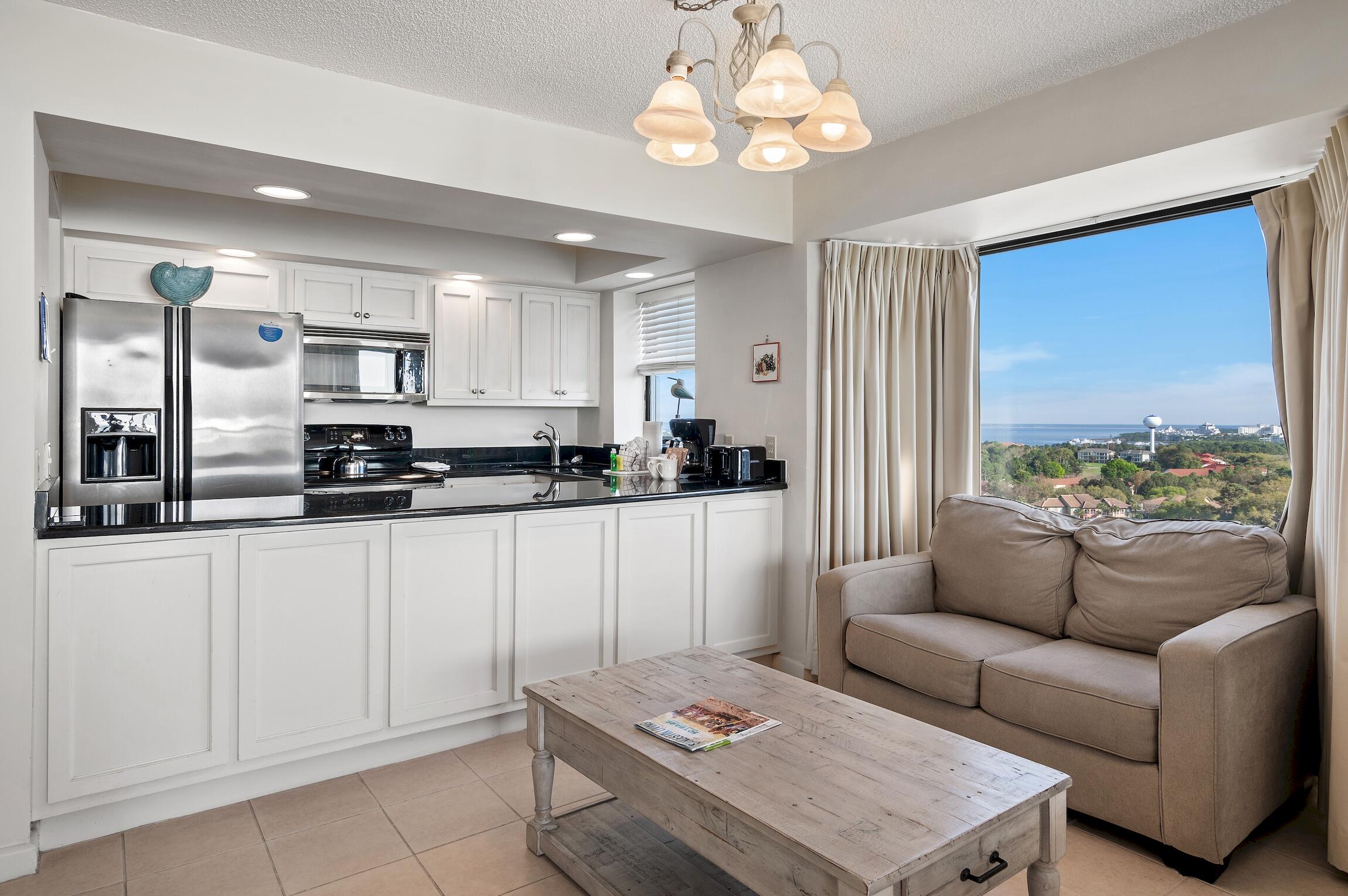 4361 Beachside 2, Unit 361 Miramar Beach, FL 32550 - Photo 14 of 29 a living room with stainless steel appliances kitchen island granite countertop furniture and a large window