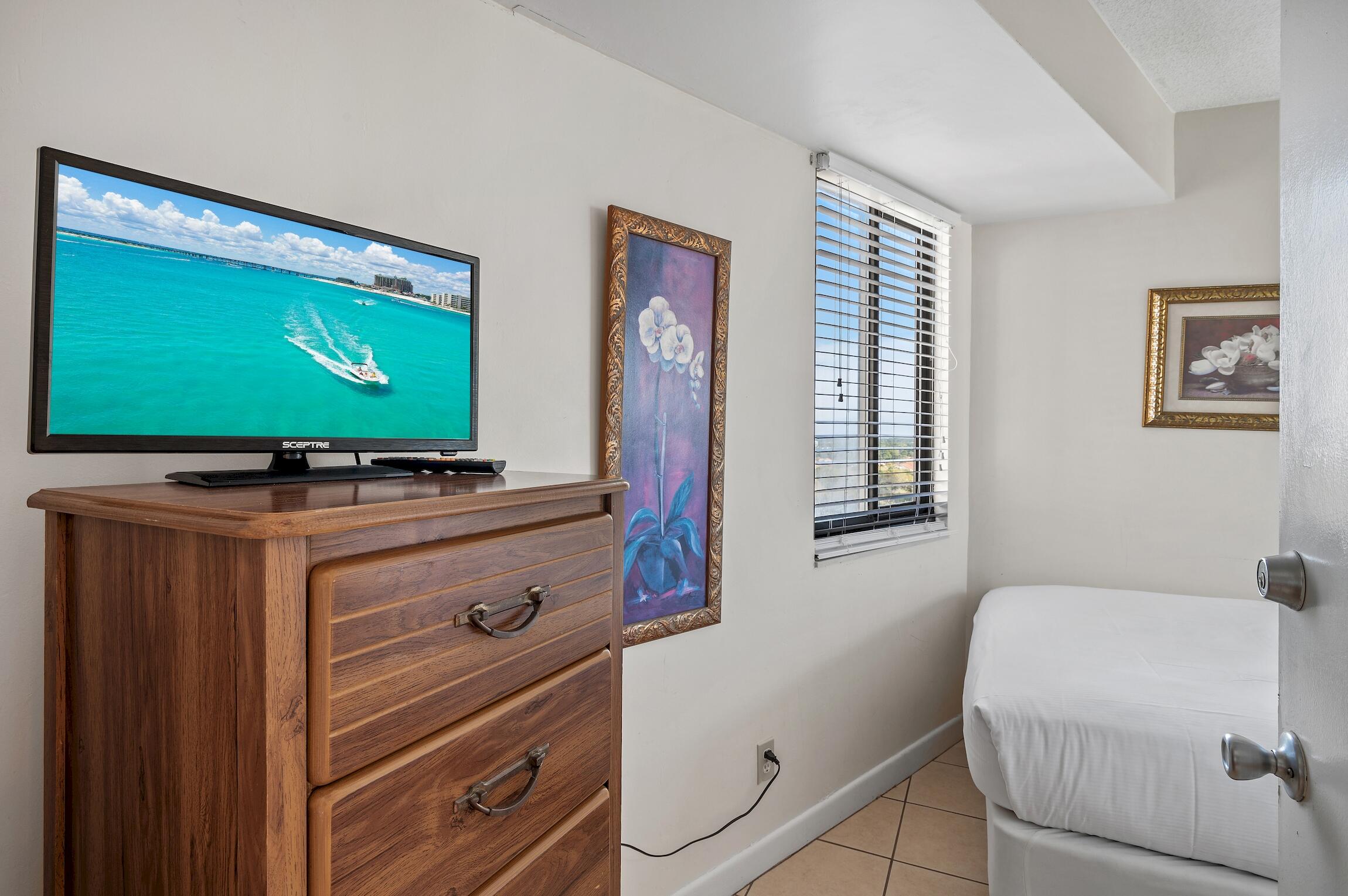 4361 Beachside 2, Unit 361 Miramar Beach, FL 32550 - Photo 17 of 29 a living room with furniture flat screen tv and guitar