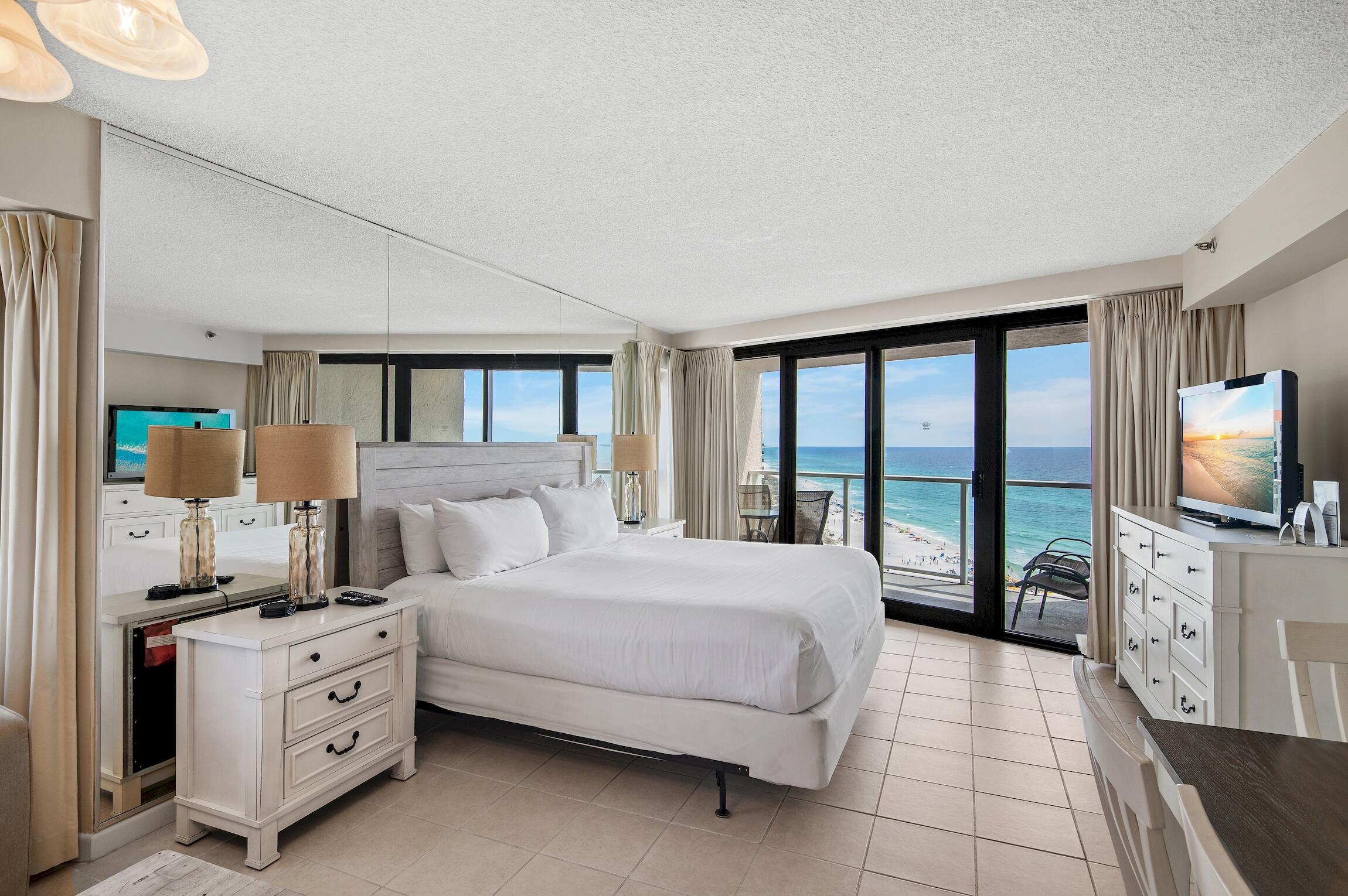 4361 Beachside 2, Unit 361 Miramar Beach, FL 32550 - Photo 9 of 29 a bedroom with a large bed and a flat tv screen on dresser