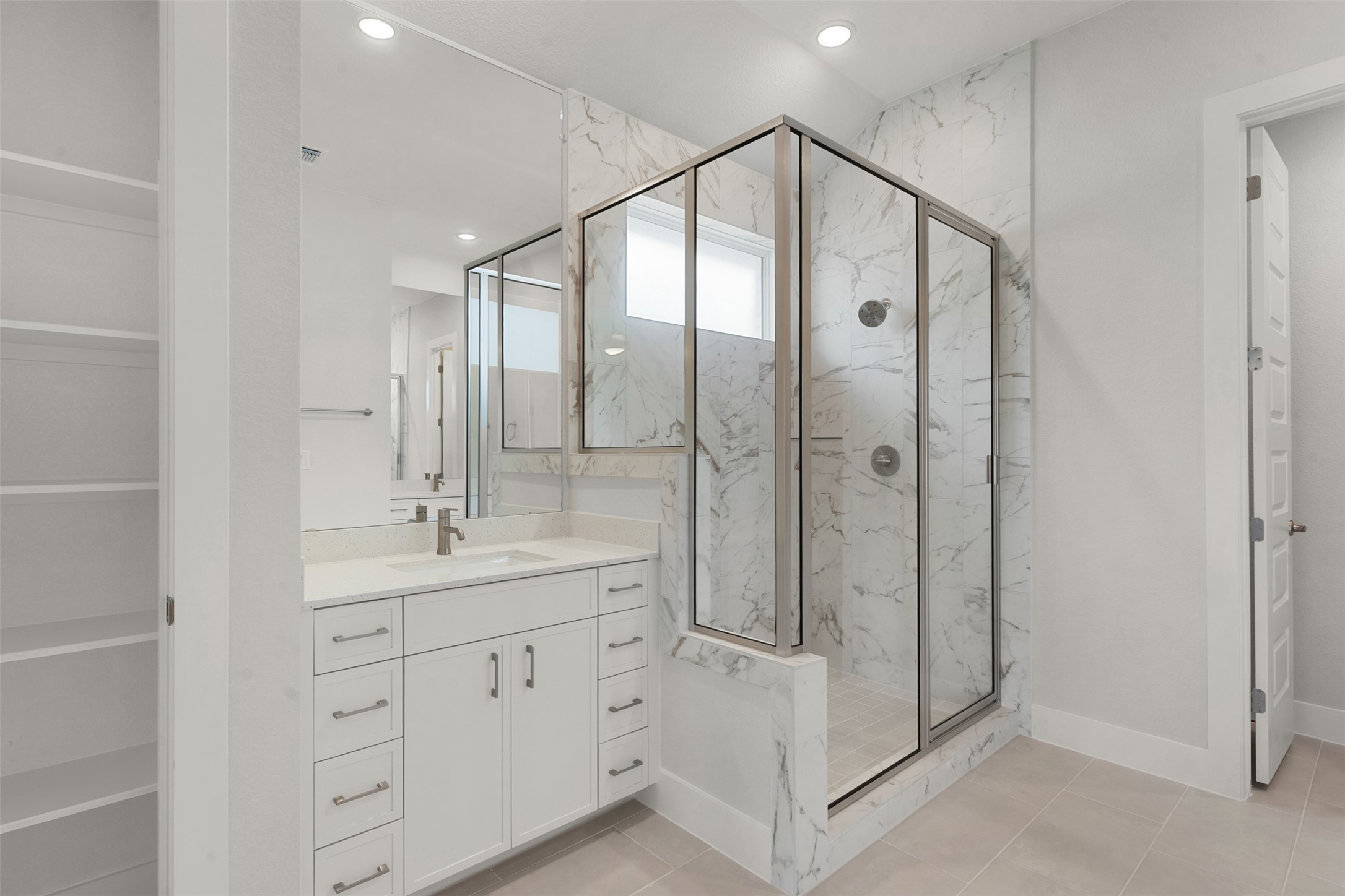 1129 Pansy Trail Georgetown, TX 78628 - Photo 17 of 29 Modern bathroom featuring a glass-enclosed shower with dual shower heads, a built-in shower bench, and marble-patterned wall tile