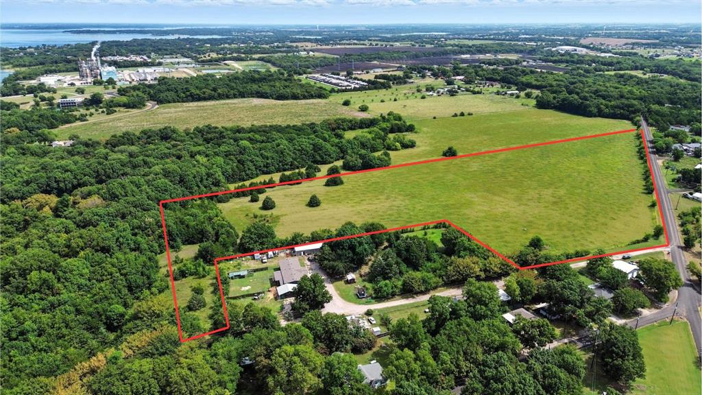 an aerial view of a houses with a yard