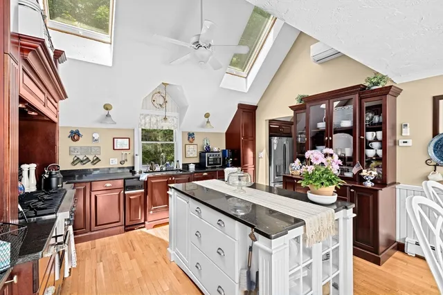 a kitchen with stainless steel appliances granite countertop a sink stove and a refrigerator