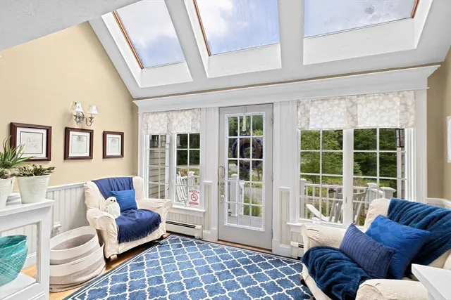 a living room with furniture and floor to ceiling windows