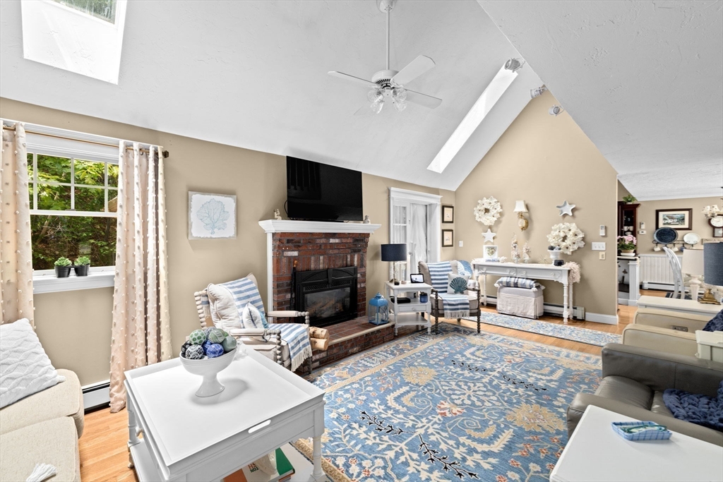 39 High Beacon Way Marshfield, MA 02050 - Photo 9 of 23 a living room with furniture a fireplace and a flat screen tv