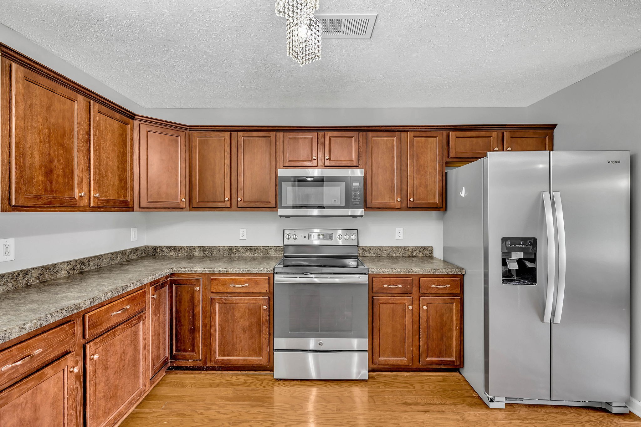 3418 Blaze Drive Murfreesboro, TN 37128 - Photo 11 of 46 a kitchen with stainless steel appliances granite countertop a stove a refrigerator and a sink with wooden cabinets