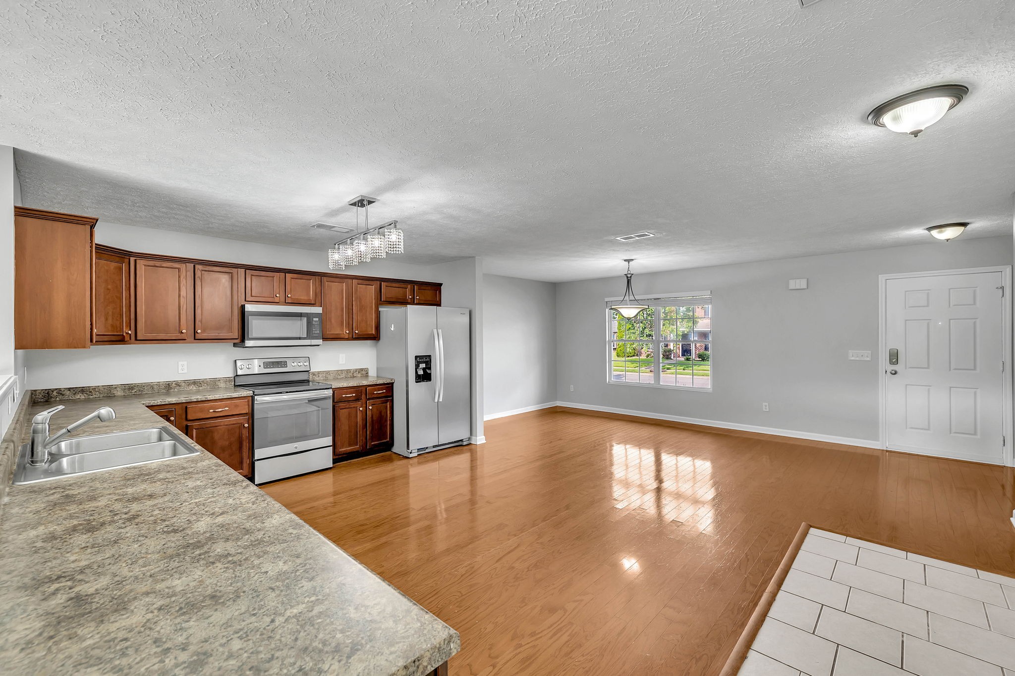 3418 Blaze Drive Murfreesboro, TN 37128 - Photo 12 of 46 a large kitchen with stainless steel appliances kitchen island granite countertop a sink and cabinets