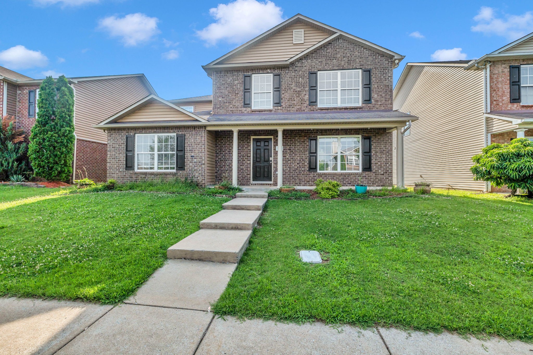 3418 Blaze Drive Murfreesboro, TN 37128 - Photo 2 of 46 a front view of a house with a yard and trees