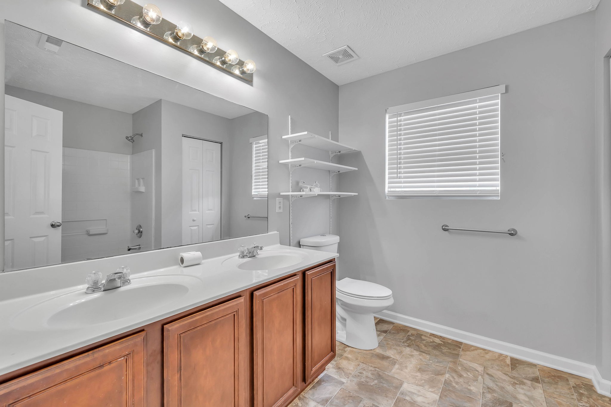 3418 Blaze Drive Murfreesboro, TN 37128 - Photo 34 of 46 a bathroom with a sink a toilet and a large mirror