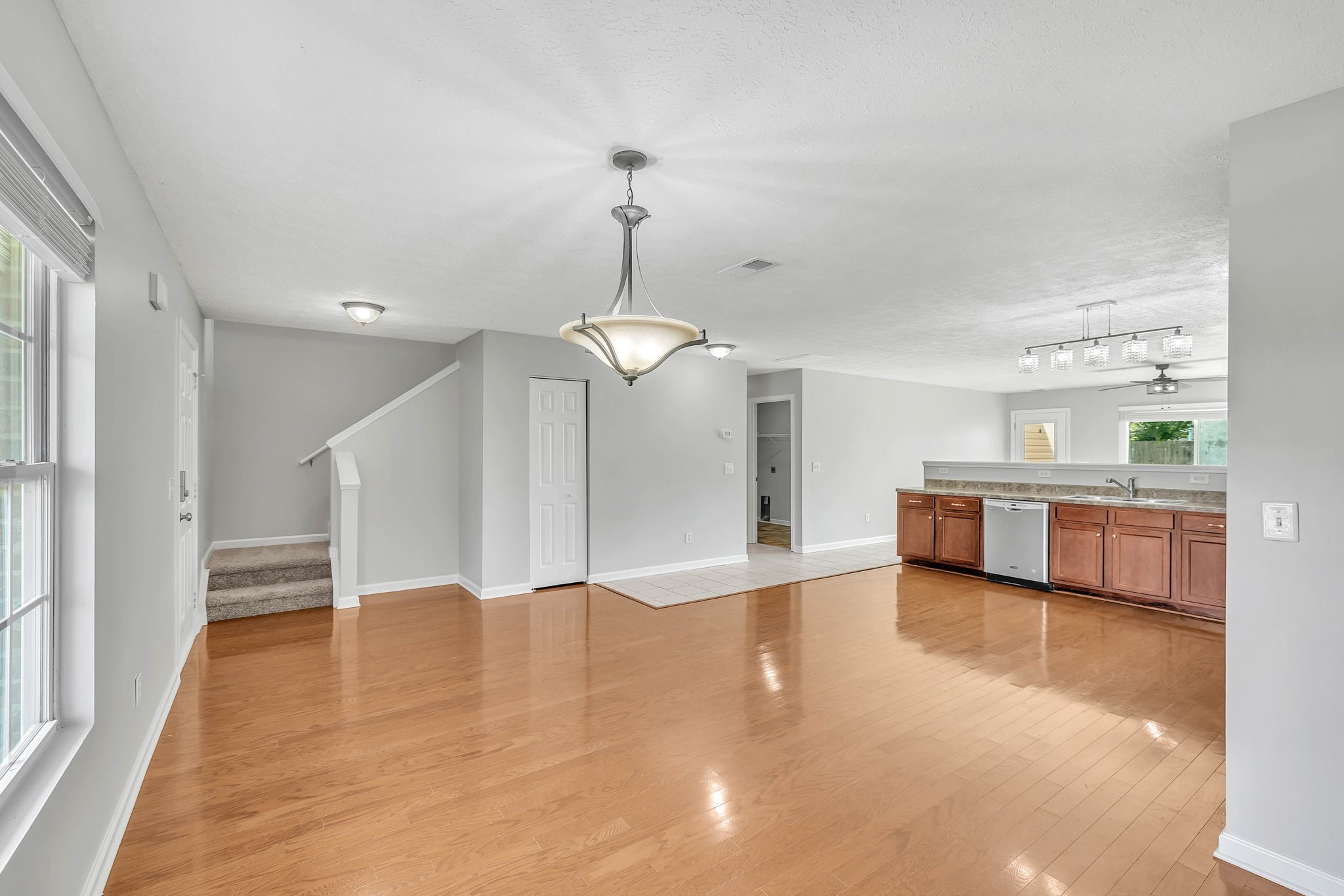 3418 Blaze Drive Murfreesboro, TN 37128 - Photo 6 of 46 a view of a big room with wooden floor windows and a ceiling fan