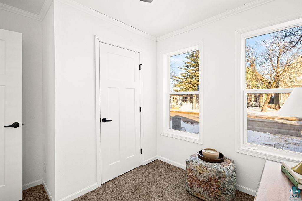 415 Cumming Avenue Superior, WI 54880 - Photo 16 of 26 Doorway to outside with carpet flooring and ornamental molding