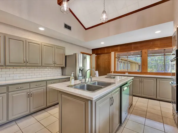 a spacious bedroom with a bed and wooden floor