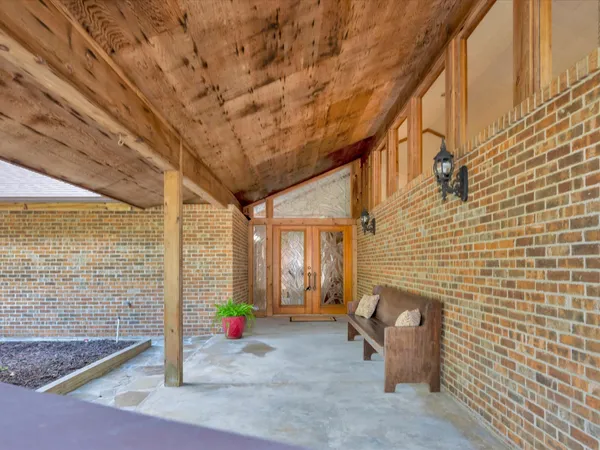 a dining room with furniture and a floor to ceiling window