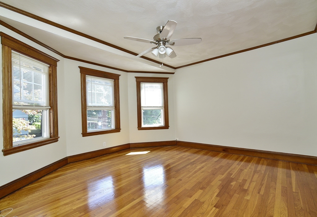 43 Oakridge Street, Unit 2 Boston, MA 02126 - Photo 3 of 8 a view of an empty room with a window and wooden floor