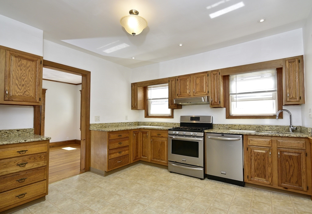 43 Oakridge Street, Unit 2 Boston, MA 02126 - Photo 4 of 8 a kitchen with stainless steel appliances granite countertop a stove and a sink
