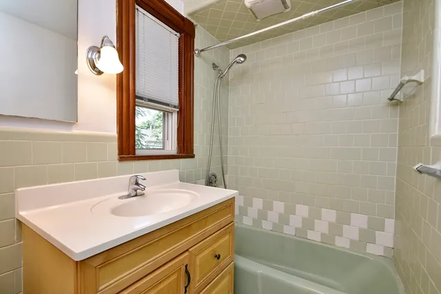 a bathroom with a sink a mirror and a bathtub