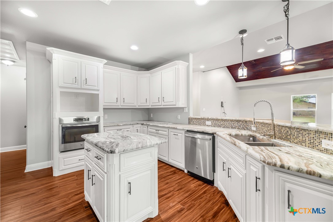 204 James Street Inez, TX 77968 - Photo 10 of 35 a kitchen with granite countertop a sink and cabinets